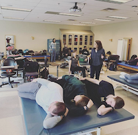 Napping in class? Nope! Third year PT students are shown here learning about the Feldenkrais method.